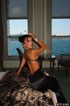 Elara black satin maxi dress showing the low open back and slim straps