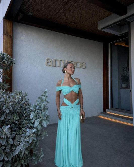 Yasmina turquoise off-the-shoulder halter two-piece maxi set featuring a cutout waist and floor-length skirt.