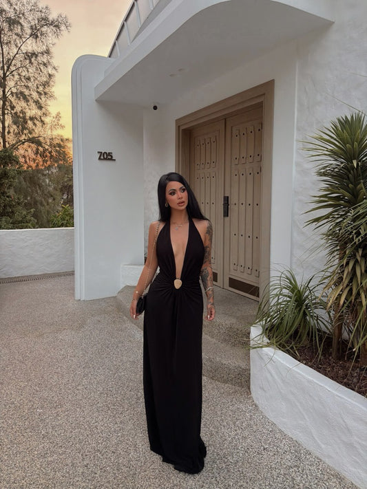 Black halter maxi dress with deep V-neckline and gold-tone waist clasp
