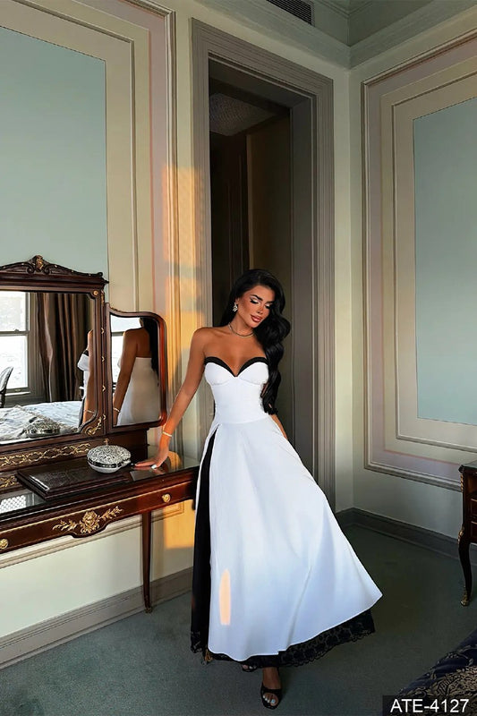 White and black strapless maxi dress with sweetheart neckline and black lace hem